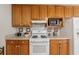 Well-equipped kitchen featuring a gas range, built-in microwave, and ample cabinetry for efficient cooking and storage at 6960 Worley Rd, Cumming, GA 30028