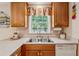 Functional kitchen with a stainless steel sink, bright window, and ample counter space for easy meal preparation at 6960 Worley Rd, Cumming, GA 30028