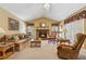 Comfortable living room offers a warm fireplace, plush seating, and natural light at 6960 Worley Rd, Cumming, GA 30028