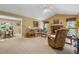 Bright living room features a cozy fireplace, plush seating, and views into the breakfast nook at 6960 Worley Rd, Cumming, GA 30028