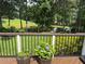Inviting back deck offers a tranquil view of the pond and lush greenery at 12162 Mountain Laurel Dr, Roswell, GA 30075