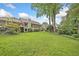 Expansive backyard with lush green lawn and mature trees, perfect for outdoor activities and relaxation at 12162 Mountain Laurel Dr, Roswell, GA 30075
