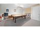 Basement space includes a pool table, bar stools, and bright lighting at 12162 Mountain Laurel Dr, Roswell, GA 30075