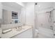 Bright bathroom with a large mirror, white tiles, and a shower-tub combination at 12162 Mountain Laurel Dr, Roswell, GA 30075