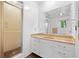 Bathroom with white vanity, double sinks, marble countertop and glass enclosed shower at 12162 Mountain Laurel Dr, Roswell, GA 30075