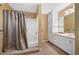 Bathroom featuring a tub/shower combination with a shower curtain, vanity, and built-in storage at 12162 Mountain Laurel Dr, Roswell, GA 30075