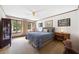 Comfortable bedroom with carpet floors, a ceiling fan, and a large window at 12162 Mountain Laurel Dr, Roswell, GA 30075