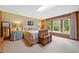 Bedroom with carpeted floor, wood-paneled wall, large windows with bench, and queen-sized bed at 12162 Mountain Laurel Dr, Roswell, GA 30075