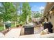 Relaxing outdoor deck featuring a seating area, grill, and picturesque views at 12162 Mountain Laurel Dr, Roswell, GA 30075