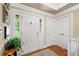 Welcoming entryway with hardwood floors, white trim, and natural light at 12162 Mountain Laurel Dr, Roswell, GA 30075