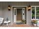 Classic front door with sidelights, decorative outdoor lighting, and a welcoming entrance at 12162 Mountain Laurel Dr, Roswell, GA 30075
