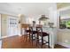 Bright kitchen boasts stainless appliances, an island with seating, and a door leading outside at 12162 Mountain Laurel Dr, Roswell, GA 30075