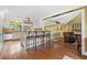 Bright kitchen boasts stainless appliances, an island with seating, and an open view to an adjacent seating area at 12162 Mountain Laurel Dr, Roswell, GA 30075