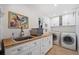 Functional laundry room with cabinets, sink, countertop space, and washer and dryer at 12162 Mountain Laurel Dr, Roswell, GA 30075