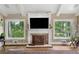 Elegant living room featuring a fireplace, hardwood floors, and picturesque windows at 12162 Mountain Laurel Dr, Roswell, GA 30075