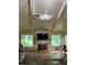 High ceilings and picture windows flood the living room with light, highlighting the fireplace and hardwood floors at 12162 Mountain Laurel Dr, Roswell, GA 30075