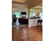 Spacious living room showcasing hardwood floors, fireplace, large TV, and open layout to dining area at 12162 Mountain Laurel Dr, Roswell, GA 30075
