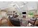 Bright living room with vaulted ceilings, fireplace, and seamless flow to dining area at 12162 Mountain Laurel Dr, Roswell, GA 30075