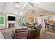 Open-concept living room with fireplace, vaulted ceiling, and seamless flow to the kitchen at 12162 Mountain Laurel Dr, Roswell, GA 30075