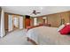 Spacious main bedroom features plush carpeting, ceiling fan, and ensuite access at 12162 Mountain Laurel Dr, Roswell, GA 30075