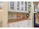 Wet bar area features custom cabinets, granite countertops, and a wine rack at 12162 Mountain Laurel Dr, Roswell, GA 30075