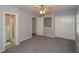 This bedroom features neutral walls and carpet, a ceiling fan, and an ensuite bath and closet at 1496 S Hairston Rd, Stone Mountain, GA 30088