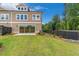 Spacious backyard with lush lawn, patio, and privacy fence, ideal for outdoor activities at 206 Grady Burrell Dr, Holly Springs, GA 30115