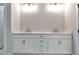 Elegant bathroom vanity featuring double sinks, sleek white cabinetry, and modern fixtures at 206 Grady Burrell Dr, Holly Springs, GA 30115