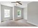 Bright bedroom featuring natural light with two windows and neutral carpet at 206 Grady Burrell Dr, Holly Springs, GA 30115