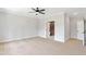 Bright bedroom boasts neutral walls, carpet flooring, ceiling fan, and attached bathroom with glass shower at 206 Grady Burrell Dr, Holly Springs, GA 30115