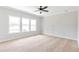Bedroom with plush carpeting, neutral walls, and three large windows providing ample natural light at 206 Grady Burrell Dr, Holly Springs, GA 30115