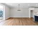 Bright dining room boasts modern chandelier and wood floors, bathed in natural light from sliding glass doors at 206 Grady Burrell Dr, Holly Springs, GA 30115