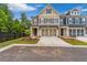 Charming two-story townhome with a neutral color palette, attached two-car garage, and well-manicured landscaping at 206 Grady Burrell Dr, Holly Springs, GA 30115