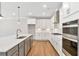 Gourmet kitchen with stainless steel appliances, custom cabinetry, a large island, and modern finishes at 206 Grady Burrell Dr, Holly Springs, GA 30115
