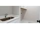 Convenient laundry room featuring a sink and additional storage cabinets at 206 Grady Burrell Dr, Holly Springs, GA 30115