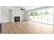 Bright living room features fireplace with tile surround, and large sliding glass doors to backyard at 206 Grady Burrell Dr, Holly Springs, GA 30115