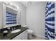 This bathroom features granite countertops, a decorative shower curtain, and a modern mirror at 3371 Spring Harbour Dr, Atlanta, GA 30340