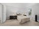 Cozy bedroom with neutral carpeting, a large window, and classic lamps on bedside tables at 3371 Spring Harbour Dr, Atlanta, GA 30340