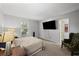 This bedroom has carpet, a large window for natural light, and an entertainment center at 3371 Spring Harbour Dr, Atlanta, GA 30340