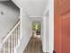 Welcoming entryway featuring hardwood floors, stairs with white railings and natural light from the adjacent living area at 3371 Spring Harbour Dr, Atlanta, GA 30340