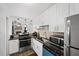 Modern kitchen with stainless steel appliances, dark countertops, and white cabinetry, seamlessly flowing into the living area at 3371 Spring Harbour Dr, Atlanta, GA 30340