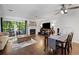 Bright living room with fireplace, hardwood floors, and sliding glass doors leading to an outdoor patio space at 3371 Spring Harbour Dr, Atlanta, GA 30340