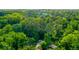 High aerial view of the home nestled in a lush, green, and heavily wooded neighborhood at 398 Baker Nw Cir, Atlanta, GA 30318