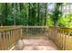 Exterior wooden back deck surrounded by mature trees at 398 Baker Nw Cir, Atlanta, GA 30318