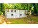 Exterior view of home with newly painted siding, basement access, and a wooden deck at 398 Baker Nw Cir, Atlanta, GA 30318