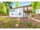 Exterior of home with newly painted siding, basement access, and a wooden deck at 398 Baker Nw Cir, Atlanta, GA 30318