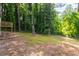Large backyard with a wooded border and a raised deck connected to the home at 398 Baker Nw Cir, Atlanta, GA 30318