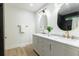 Bright bathroom featuring marble countertops, oval mirrors, and bronze fixtures at 398 Baker Nw Cir, Atlanta, GA 30318