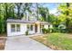 Charming single story home with neutral paint, manicured shrubs, and a lovely walkway leading to the front door at 398 Baker Nw Cir, Atlanta, GA 30318