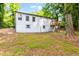 Back exterior showcasing white siding, grey trim, wooden deck, and basement entry at 398 Baker Nw Cir, Atlanta, GA 30318